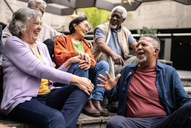 Group of mature friends laughing together outdoors